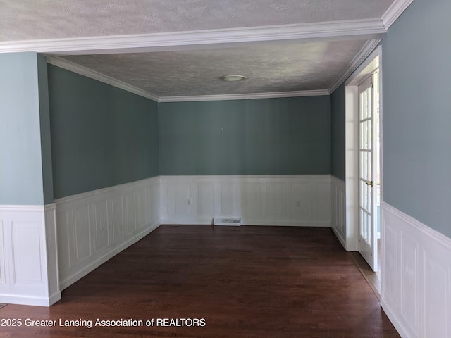 15632 Park Lake Rd, East Lansing, MI 48823 - unfurnished room with dark wood-style flooring, a wainscoted wall, and a textured ceiling