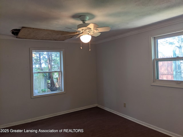 15632 Park Lake Rd, East Lansing, MI 48823 - unfurnished room featuring healthy amount of natural light, ornamental molding, ceiling fan, baseboards, and dark wood-style floors