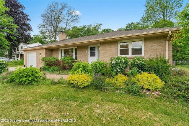 5195 E Brookfield Dr, East Lansing, MI 48823 - single story home featuring a garage, brick siding, a chimney, and a front lawn