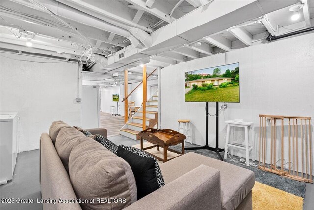 5195 E Brookfield Dr, East Lansing, MI 48823 - living room featuring stairs and concrete flooring
