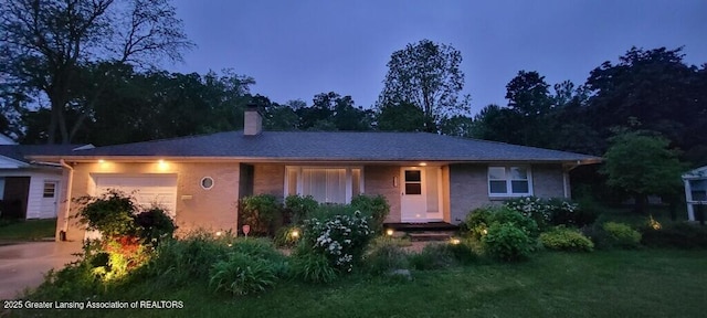 5195 E Brookfield Dr, East Lansing, MI 48823 - view of front of home featuring an attached garage and a chimney