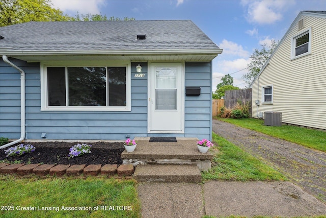 1718 Victor Ave, Lansing, MI 48910 - view of front of home with central air condition unit and a shingled roof