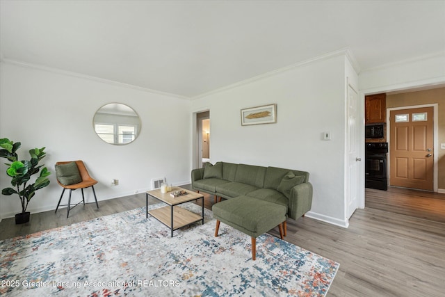 1718 Victor Ave, Lansing, MI 48910 - living area with crown molding, light wood-style flooring, and baseboards
