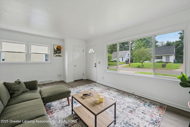 1718 Victor Ave, Lansing, MI 48910 - living room featuring wood finished floors, baseboards, and crown molding