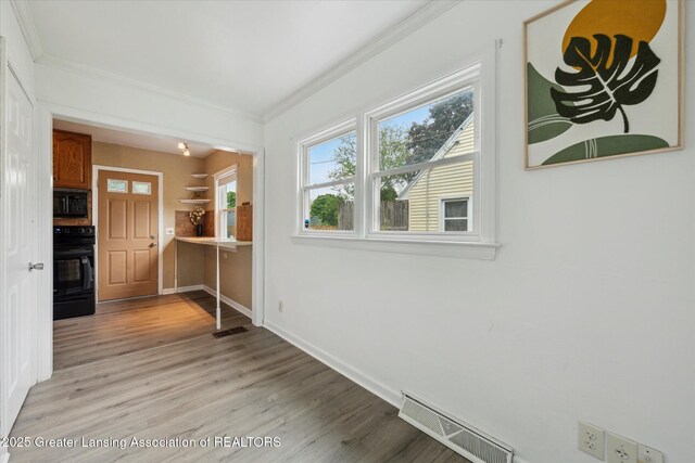 1718 Victor Ave, Lansing, MI 48910 - corridor with ornamental molding, light wood finished floors, and baseboards
