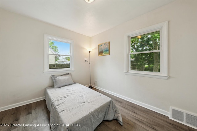 1718 Victor Ave, Lansing, MI 48910 - bedroom with baseboards and dark wood-type flooring
