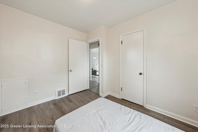 1718 Victor Ave, Lansing, MI 48910 - bedroom with wood finished floors and baseboards