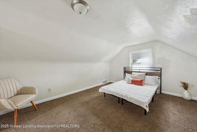 1718 Victor Ave, Lansing, MI 48910 - carpeted bedroom featuring vaulted ceiling and baseboards