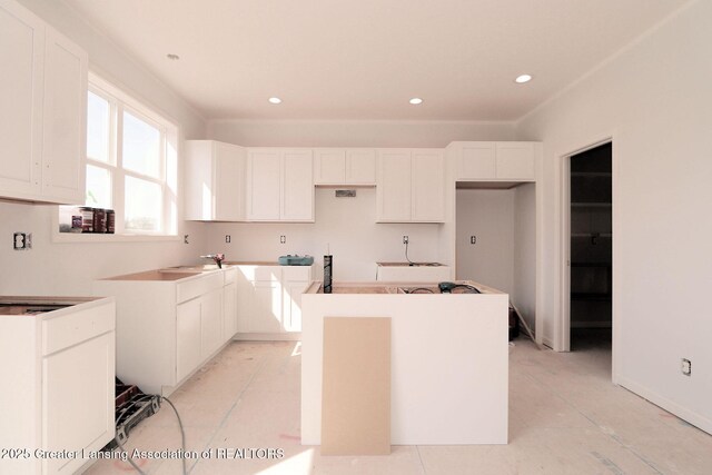 606 Launch Point Dr, Perry, MI 48872 - kitchen with a center island, white cabinets, and recessed lighting