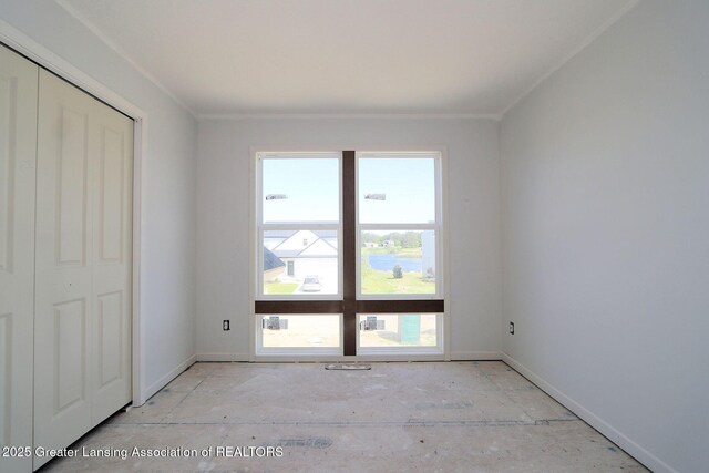 606 Launch Point Dr, Perry, MI 48872 - unfurnished bedroom with ornamental molding and baseboards