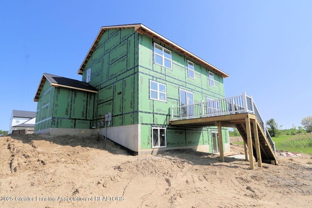 606 Launch Point Dr, Perry, MI 48872 - rear view of property with a sunroom, a deck, and stairway