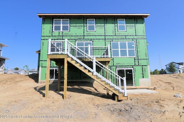 606 Launch Point Dr, Perry, MI 48872 - back of property featuring stairs and a deck