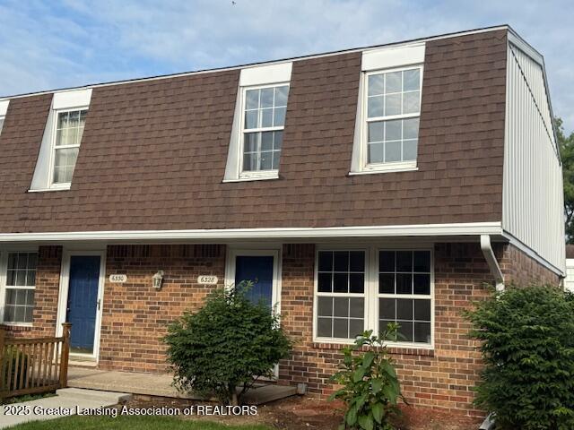 6328 Beechfield Dr, Lansing, MI 48911 - view of front of home featuring roof with shingles and brick siding