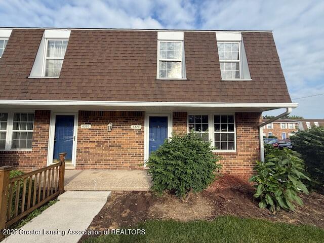 6328 Beechfield Dr, Lansing, MI 48911 - view of front of home featuring mansard roof, roof with shingles, and brick siding