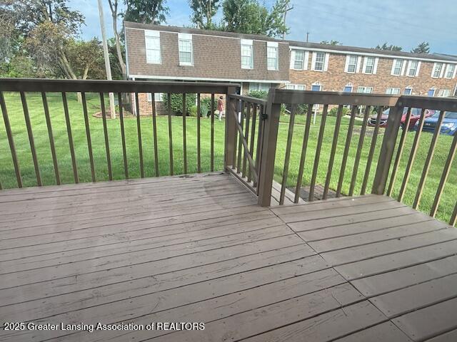 6328 Beechfield Dr, Lansing, MI 48911 - wooden deck featuring a lawn