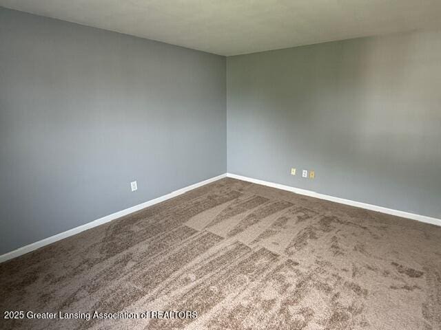 6328 Beechfield Dr, Lansing, MI 48911 - unfurnished room featuring dark colored carpet and baseboards