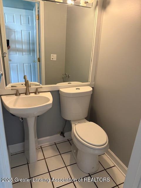 6328 Beechfield Dr, Lansing, MI 48911 - half bathroom with toilet and tile patterned flooring
