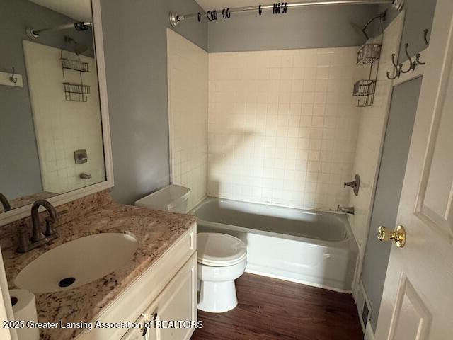 6328 Beechfield Dr, Lansing, MI 48911 - bathroom featuring wood finished floors, vanity, and shower / bath combination