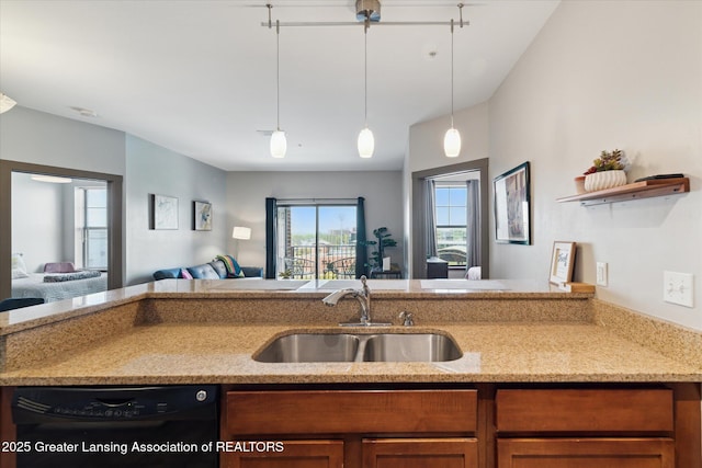 500 E Michigan Ave Unit 417, Lansing, MI 48912 - kitchen featuring dishwasher, a sink, open floor plan, decorative light fixtures, and brown cabinets