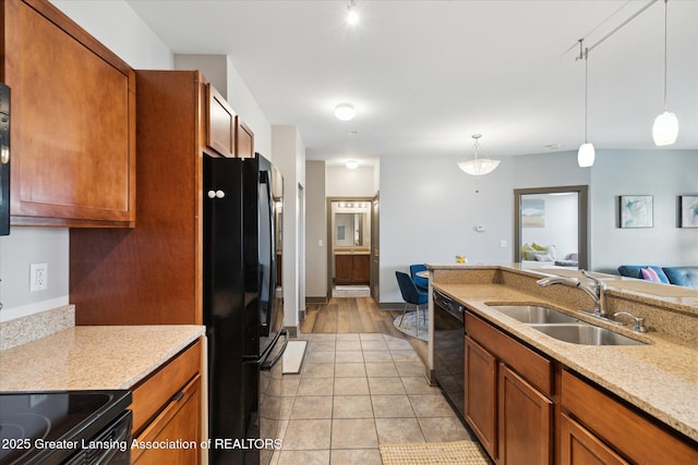 500 E Michigan Ave Unit 417, Lansing, MI 48912 - kitchen featuring black appliances, a sink, rail lighting, and brown cabinetry