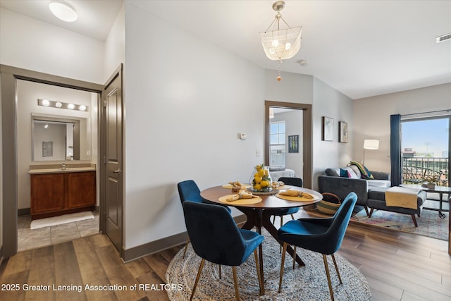 500 E Michigan Ave Unit 417, Lansing, MI 48912 - dining area with wood finished floors and baseboards