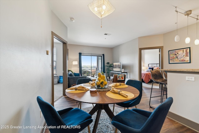 500 E Michigan Ave Unit 417, Lansing, MI 48912 - dining room featuring wood finished floors and baseboards