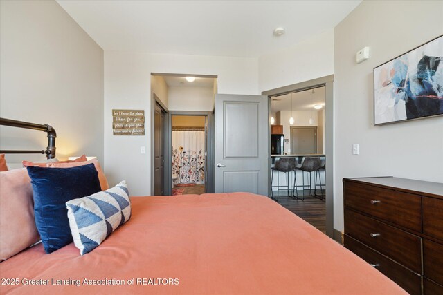 500 E Michigan Ave Unit 417, Lansing, MI 48912 - bedroom featuring fridge and wood finished floors