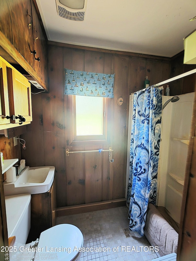 6574 Sawmill Rd, Harrison, MI 48625 - bathroom with a shower with curtain, toilet, wooden walls, a bath, and a sink