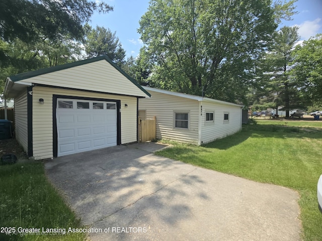 6574 Sawmill Rd, Harrison, MI 48625 - view of front of house with an outbuilding, asphalt driveway, a front yard, and a garage