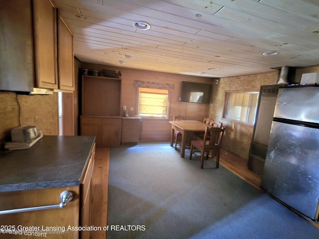 6574 Sawmill Rd, Harrison, MI 48625 - kitchen with wooden ceiling, freestanding refrigerator, plenty of natural light, dark countertops, and brown cabinets