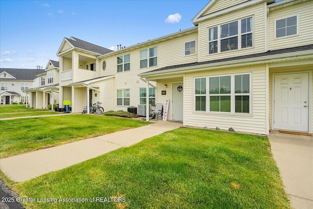 12947 Townsend Dr Unit 412, Grand Ledge, MI 48837 - view of property with a front lawn, a residential view, and central air condition unit