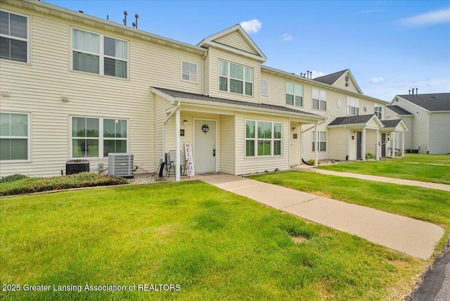 12947 Townsend Dr Unit 412, Grand Ledge, MI 48837 - view of property featuring central air condition unit and a front yard