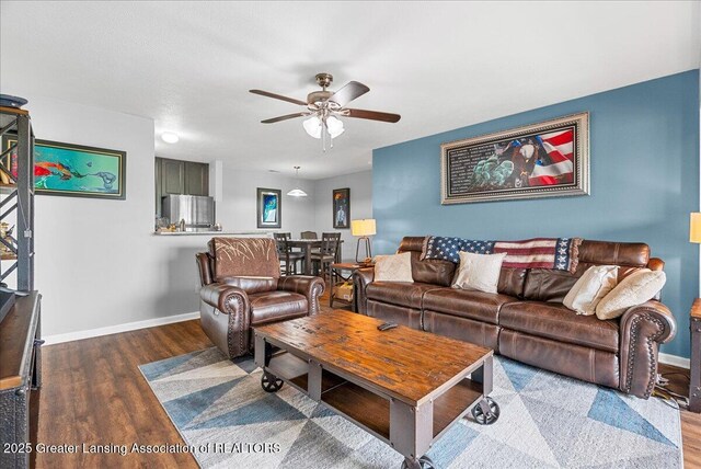 12947 Townsend Dr Unit 412, Grand Ledge, MI 48837 - living room with wood finished floors, ceiling fan, and baseboards