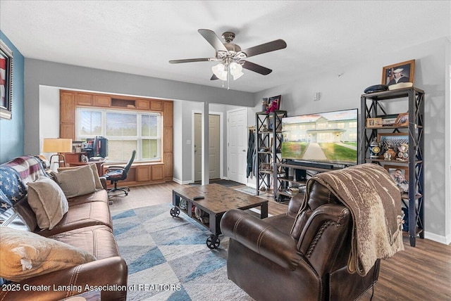 12947 Townsend Dr Unit 412, Grand Ledge, MI 48837 - living room featuring wood finished floors, ceiling fan, and baseboards