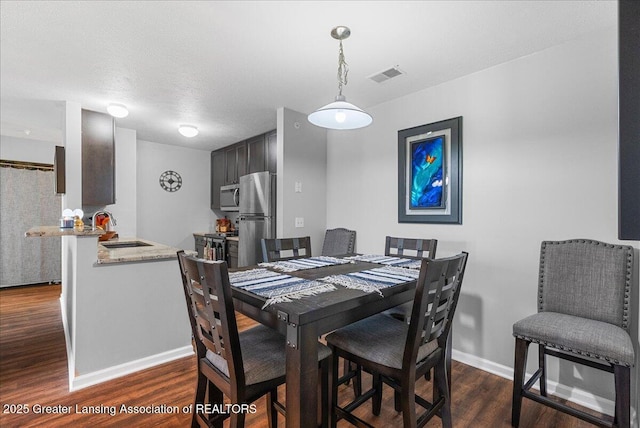 12947 Townsend Dr Unit 412, Grand Ledge, MI 48837 - dining area with dark wood-type flooring and baseboards