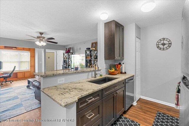 12947 Townsend Dr Unit 412, Grand Ledge, MI 48837 - kitchen with a sink, a peninsula, dishwasher, a textured ceiling, and ceiling fan