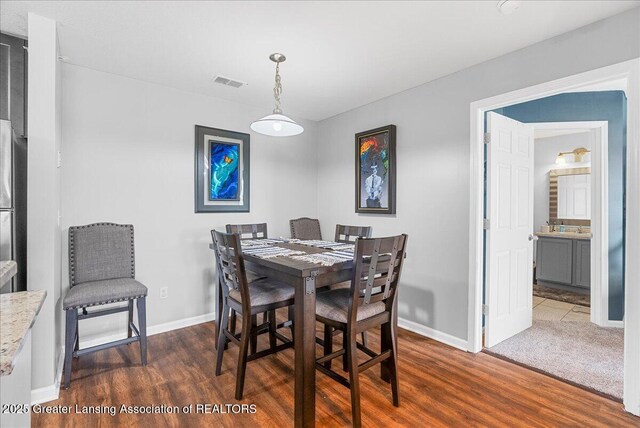 12947 Townsend Dr Unit 412, Grand Ledge, MI 48837 - dining area with dark wood-style flooring and baseboards