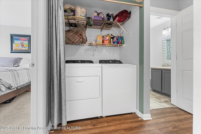 12947 Townsend Dr Unit 412, Grand Ledge, MI 48837 - washroom with independent washer and dryer and wood finished floors