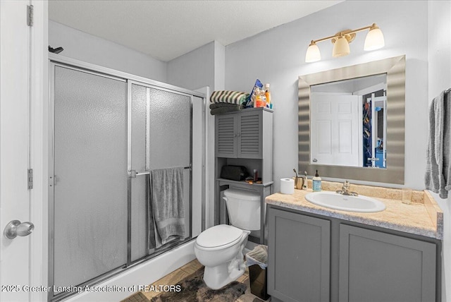 12947 Townsend Dr Unit 412, Grand Ledge, MI 48837 - full bathroom featuring a shower stall, toilet, and vanity