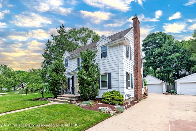 544 Collingwood Dr, East Lansing, MI 48823 - traditional home featuring a garage, a chimney, a front lawn, and an outdoor structure