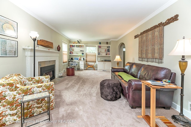 544 Collingwood Dr, East Lansing, MI 48823 - carpeted living area with crown molding, a fireplace with flush hearth, arched walkways, and built in features