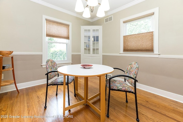 544 Collingwood Dr, East Lansing, MI 48823 - dining space with plenty of natural light, crown molding, light wood-type flooring, and a chandelier