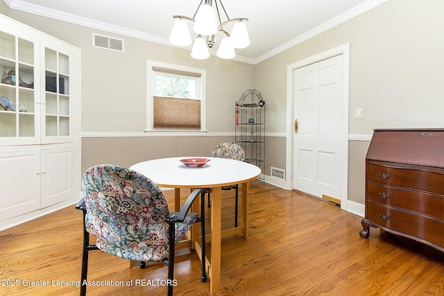 544 Collingwood Dr, East Lansing, MI 48823 - dining space with a chandelier, light wood-type flooring, and crown molding
