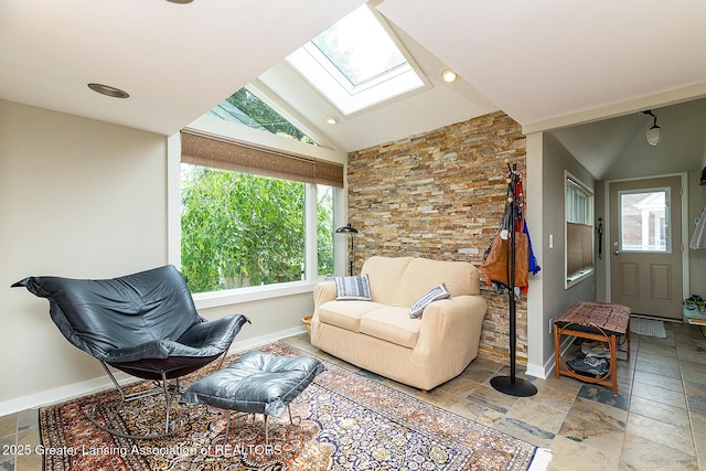 544 Collingwood Dr, East Lansing, MI 48823 - living area featuring a skylight, vaulted ceiling, plenty of natural light, and stone tile floors