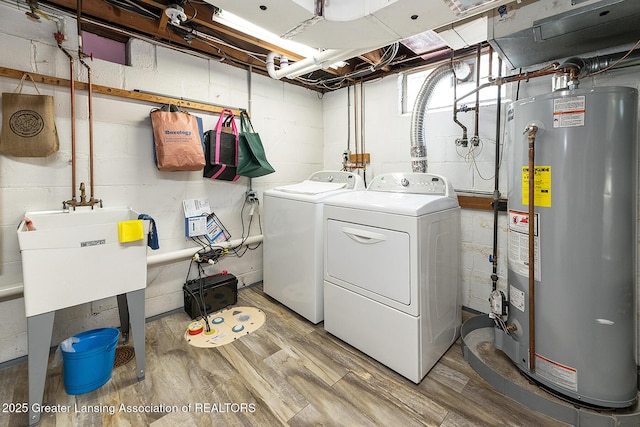 544 Collingwood Dr, East Lansing, MI 48823 - laundry area with gas water heater, washer and dryer, light wood-type flooring, and concrete block wall