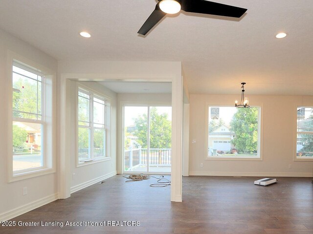 623 Aquila Dr, East Lansing, MI 48823 - unfurnished room featuring baseboards, dark wood-type flooring, a ceiling fan, a chandelier, and recessed lighting