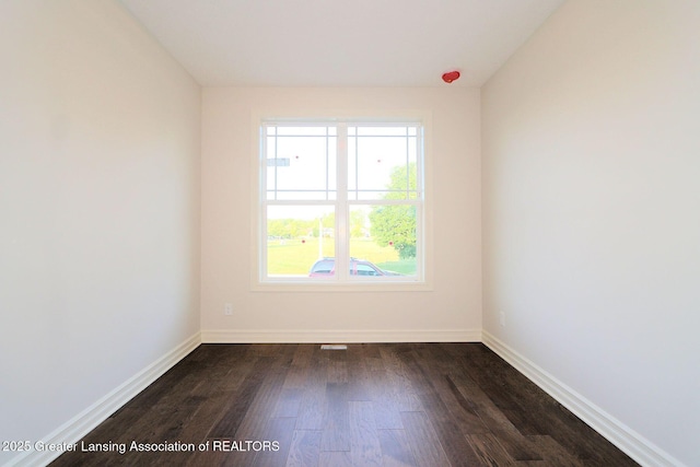 623 Aquila Dr, East Lansing, MI 48823 - unfurnished room featuring dark wood-style floors and baseboards