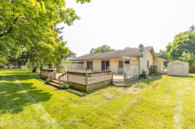 1802 Rockdale Ave, Lansing, MI 48917 - rear view of house with a lawn, a chimney, and a wooden deck