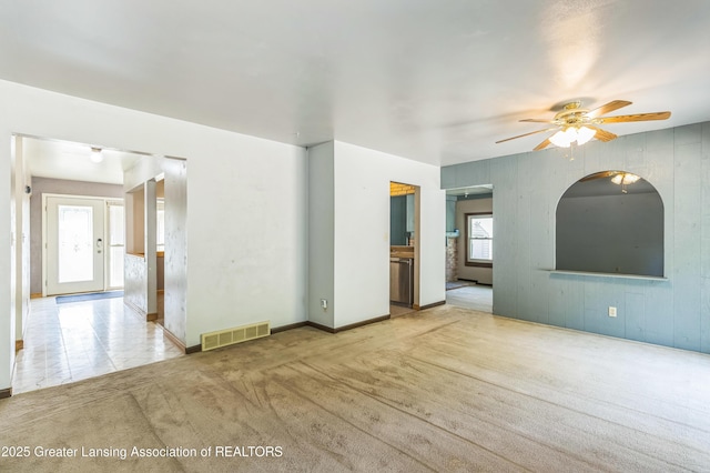1802 Rockdale Ave, Lansing, MI 48917 - unfurnished living room with a ceiling fan, carpet, and baseboards