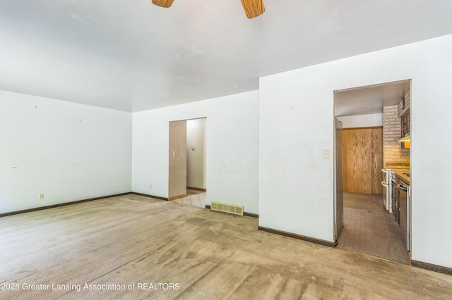 1802 Rockdale Ave, Lansing, MI 48917 - spare room with a ceiling fan, light carpet, and baseboards